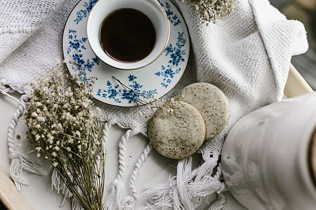 white and blue floral ceramic cup and saucer thumbnail