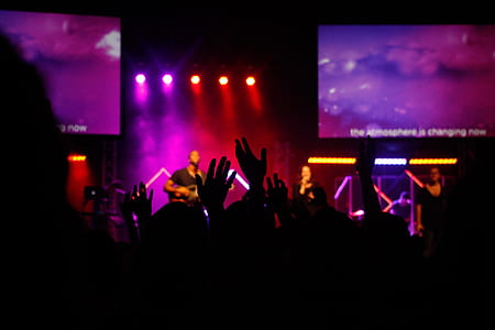 musician in front of group of people thumbnail