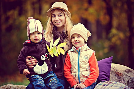 woman holding baby beside boy thumbnail