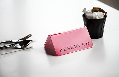 pink reserved signage on table thumbnail
