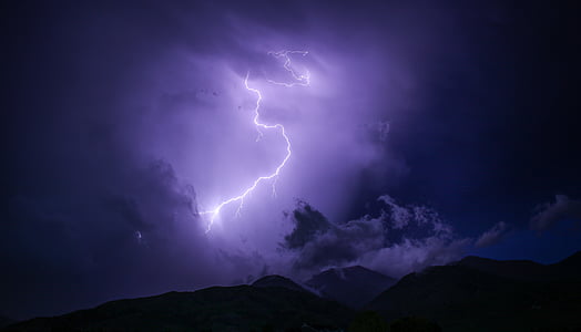 lightning bolt over mountain during nighttime thumbnail