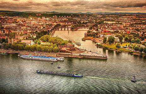aerial photography of boats on body of water near city thumbnail