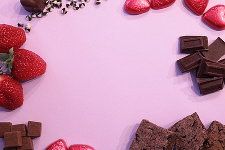 strawberries and chocolates on white surface thumbnail