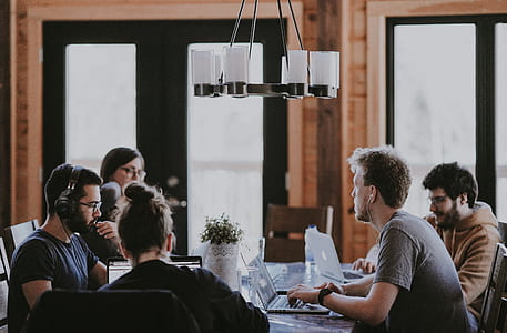 group of people infront of laptop discussing meeting indoors thumbnail