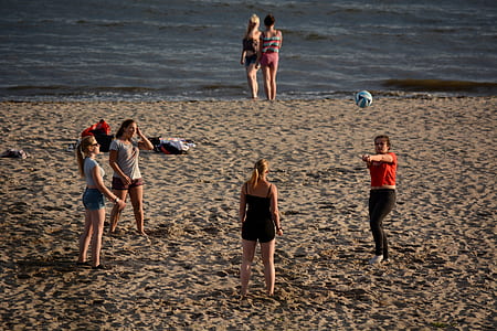 womens on beach during daytime thumbnail