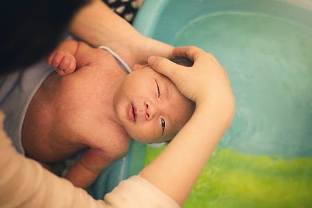 high angel photography of baby about to take a bath thumbnail
