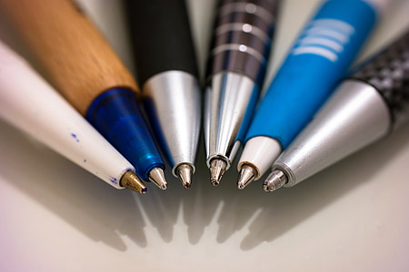 assorted-color pen on white surface thumbnail