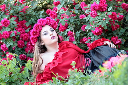 woman posing near flowers during daytime thumbnail