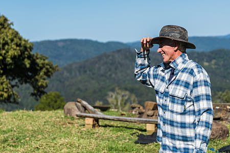 Man Wearing Blue and White Checked Sport Shirt and Black Hat thumbnail