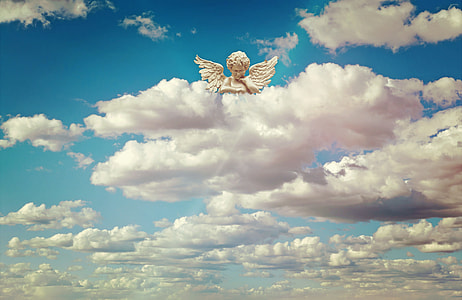 angel statuette above white clouds at daytime thumbnail
