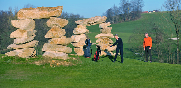 two person playing golf under blue sky thumbnail