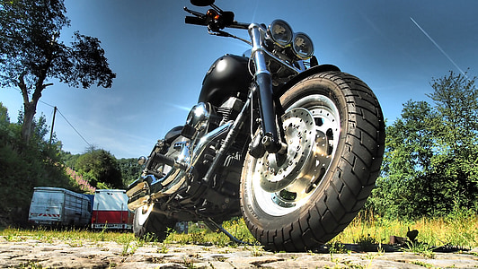 black cruiser motorcycle on road thumbnail
