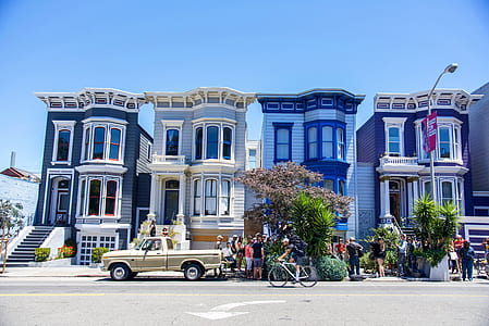 group of people standing in front of house thumbnail