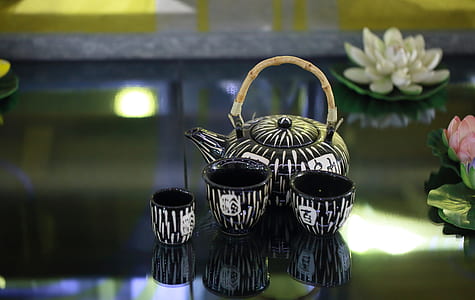 teapot with three teacups on table thumbnail
