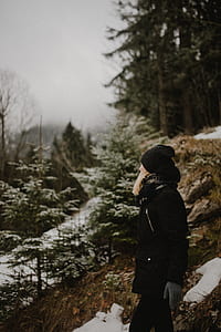 selective focus photo of woman standing near mountain thumbnail