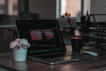 Macbook on Table Beside Mug in Shallow Focus Photography thumbnail