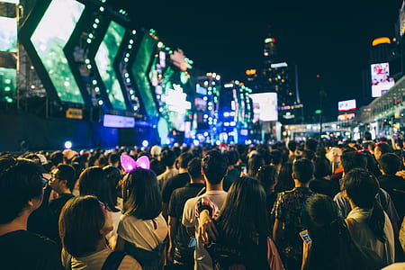 crowd of people gathered near buildings thumbnail