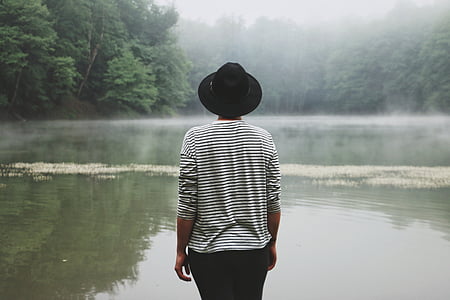 person standing near body of water thumbnail