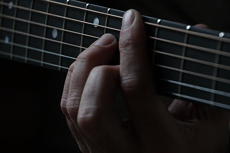 person holding guitar strings thumbnail
