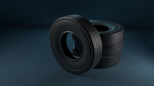 four vehicle tires on gray surface thumbnail