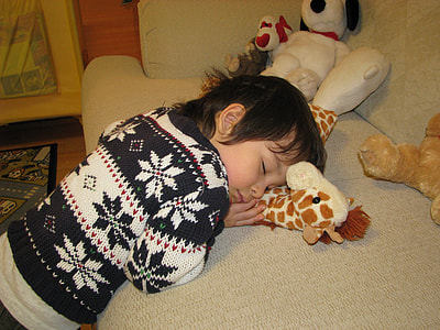 boy sleeping on gray sofa thumbnail