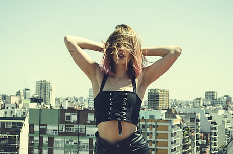 Woman Holding Her Head Wearing Black Sleeveless Crop Top thumbnail