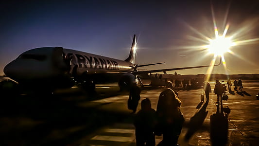group of people near airliner at daytime thumbnail