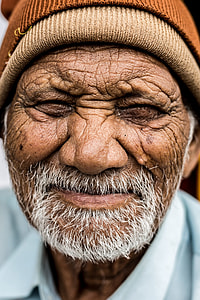 man wearing brown knit cap close up photo thumbnail