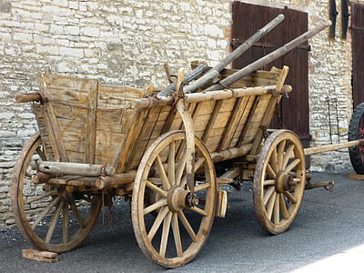brown wooden carriage parked near house thumbnail