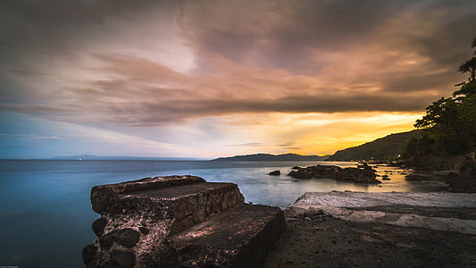 landscape photography of body of water with mountains thumbnail