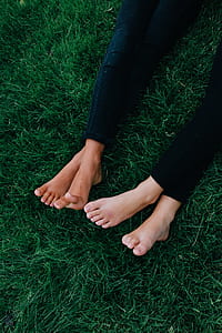 two person lying on green lawn grass wearing black denim jeans thumbnail