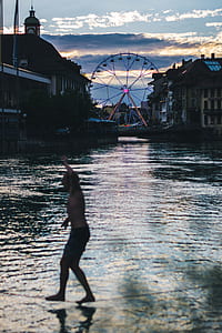 photography of person balancing on string over body of water thumbnail