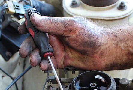person holding black and red screwdriver thumbnail