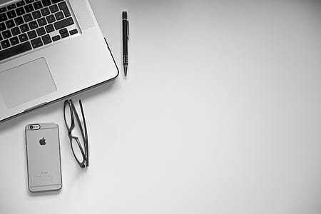 space gray iPhone 6 with clear rear case near eyeglasses and MacBook Pro thumbnail