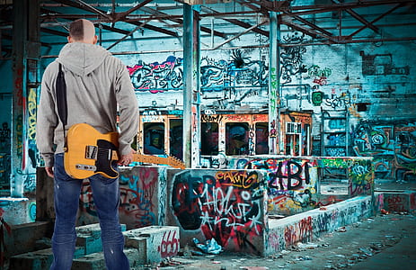 man holding yellow electric guitar thumbnail