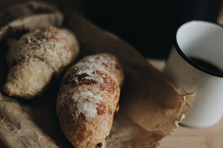 two pastries beside white mug thumbnail