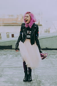 Woman Wearing Black Jacket Holding Pink Flowers thumbnail