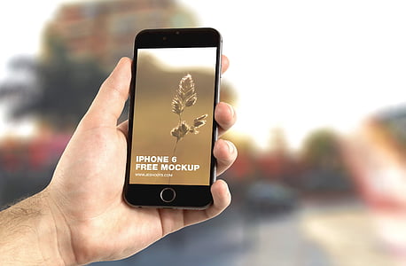 person holding iPhone with iPhone 6 free mockup display thumbnail