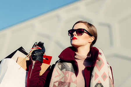 selective focus photograph of woman holding shopping bags thumbnail