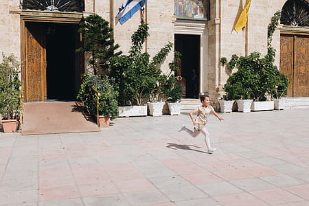 Boy Running on Gray Concrete Floor thumbnail