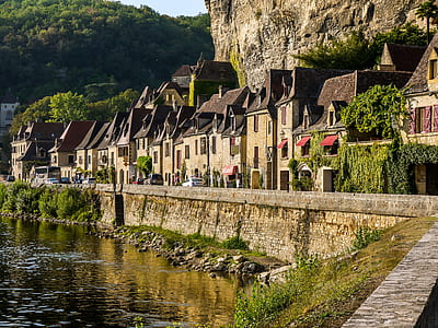 photo of gray concrete houses near body water during daytime thumbnail