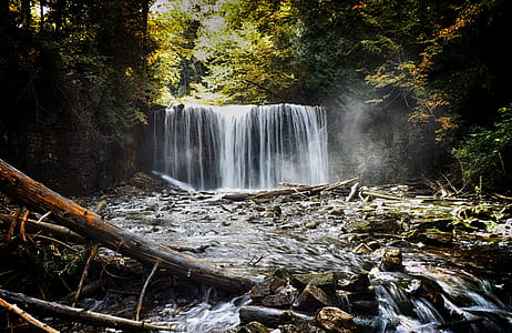 waterfalls near green leafed trees at daytime thumbnail