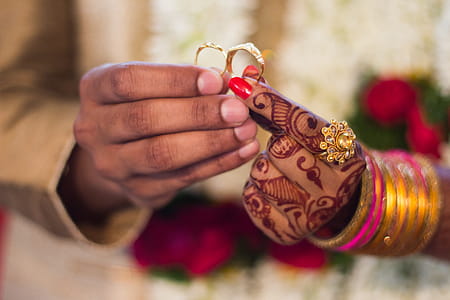 Man and Woman Holding Wedding Rings thumbnail