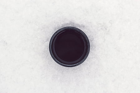 black paint in can on white surface thumbnail