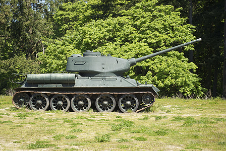 green military tank near green leafed trees at daytime thumbnail