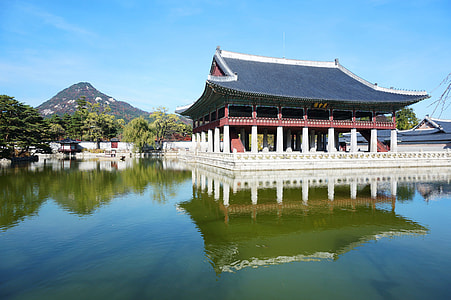 white and black concrete pagoda near body of water thumbnail