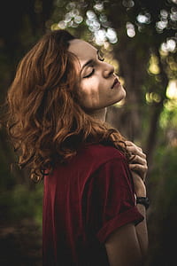 selective focus of woman closing her eyes while hands on her chest at day time thumbnail