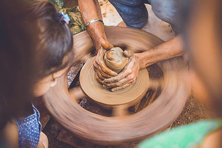 person making clay pot thumbnail