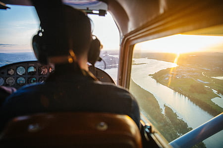 man inside of plane and showing river during daytime thumbnail