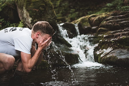 man washing face on stream thumbnail